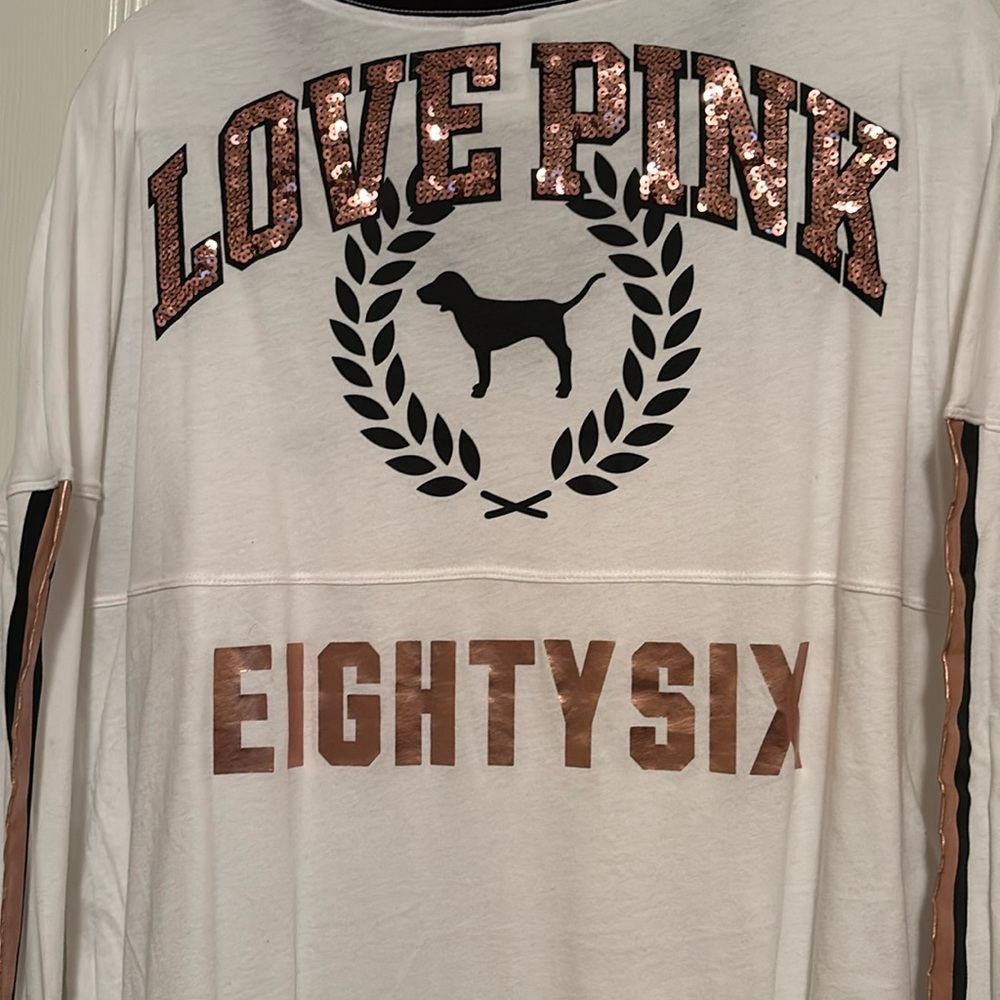 PINK EIGHY SIX rose gold glitter letters and strips down the sleeve.
